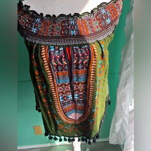 Off shoulder smocked tunic with Pom Pom hem.